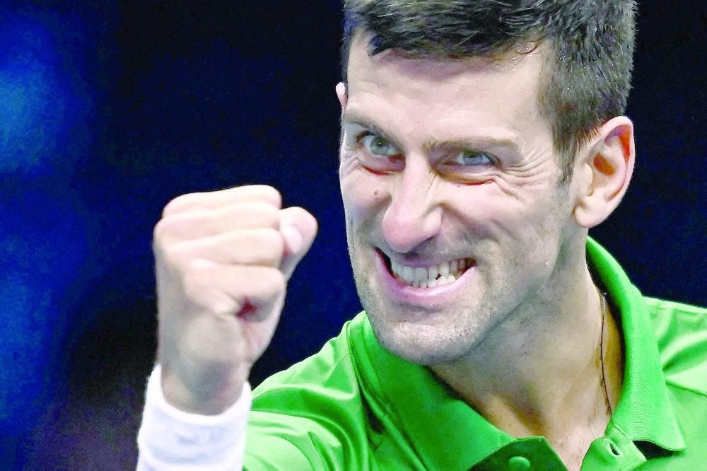 TOPSHOT - Serbia's Novak Djokovic celebrates after winning his round-robin match against Russia's Andrey Rublev on November 16, 2022 at the ATP Finals tennis tournament in Turin. (Photo by Marco BERTORELLO / AFP)

