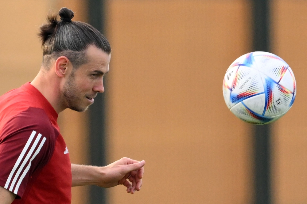 Wales' forward Gareth Bale eyes the ball during a training session at the Al Sadd SC in Doha on November 17, 2022, ahead of the Qatar 2022 World Cup football tournament. (Photo by Nicolas TUCAT / AFP)

