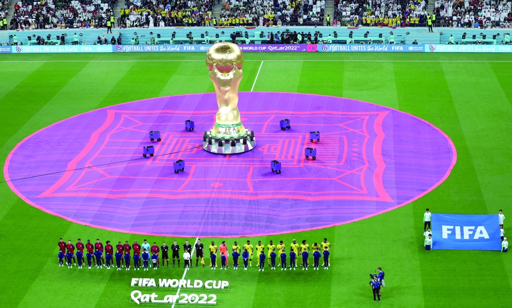 A Fifa World Cup trophy replica is seen on the pitch before the match. — Reuters