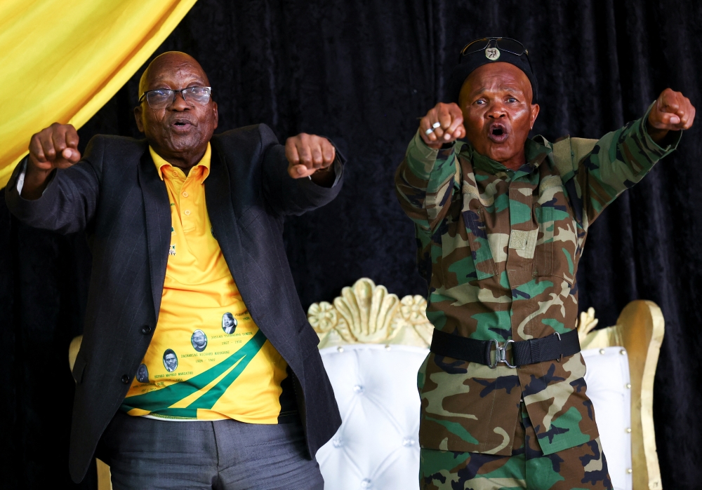 Former South African President Jacob Zuma dances with a military veteran, Fumanekile Booi, at the African National Congress Youth League political education meeting in Philippi in Cape Town, South Africa, November 19, 2022. REUTERS/Esa Alexander