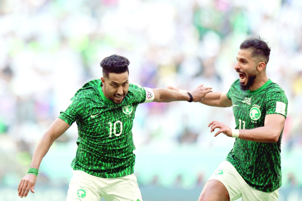 Saudi Arabia's midfielder #10 Salem Al-Dawsari (L) celebrates with Saudi Arabia's forward #11 Saleh Al-Shehri after scoring his team's second goal during the Qatar 2022 World Cup Group C football match between Argentina and Saudi Arabia at the Lusail Stadium in Lusail, north of Doha on November 22, 2022. (Photo by Khaled DESOUKI / AFP)

