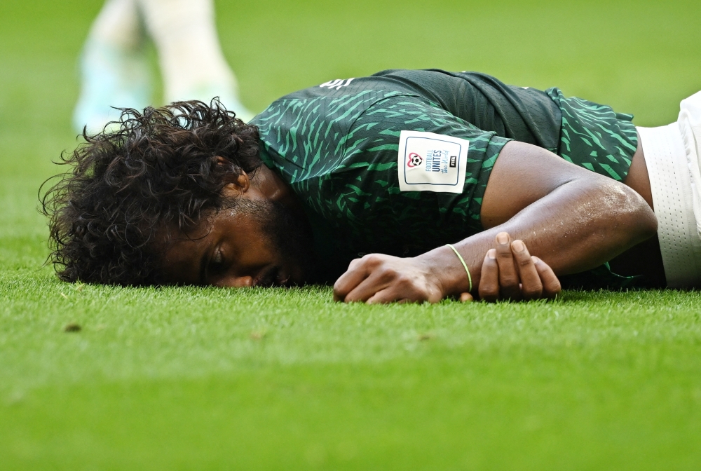 Saudi Arabia's Yasser Al-Shahrani after sustaining an injury 