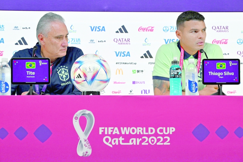 Brazil's coach Tite (L) and Brazil's defender Thiago Silva attend a press conference at the Qatar National Convention Center (QNCC) in Doha on November 23, 2022, on the eve of the Qatar 2022 World Cup football match between Brazil and Serbia. (Photo by NELSON ALMEIDA / AFP)

