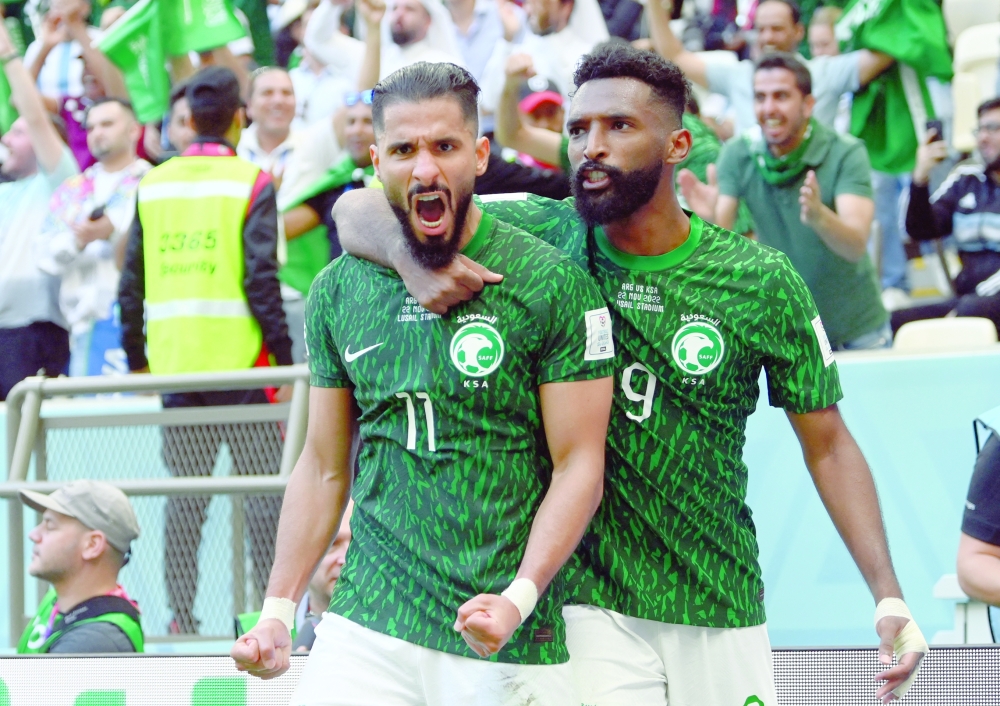 Soccer Football - Fifa World Cup Qatar 2022 - Group C - Argentina v Saudi Arabia - Lusail Stadium, Lusail, Qatar - November 22, 2022  Saudi Arabia's Saleh al Shehri celebrates scoring their first goal with Feras al Brikan REUTERS/Annegret Hilse