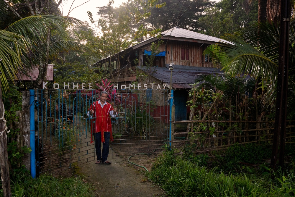 Saw John, who runs the Koh Hee Island Home in the Mayabunder area, opens the gate of his homestay an eight-hour drive north of Port Blair in the Andaman Islands in India in November 2022. (Poras Chaudhary/The New York Times)