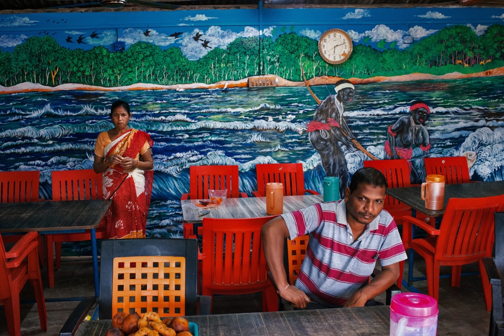 A mural depicts members of the Jarawa Indigenous group, in a small restaurant in Baratang in the Andaman Islands in India in November 2022. (Poras Chaudhary/The New York Times)