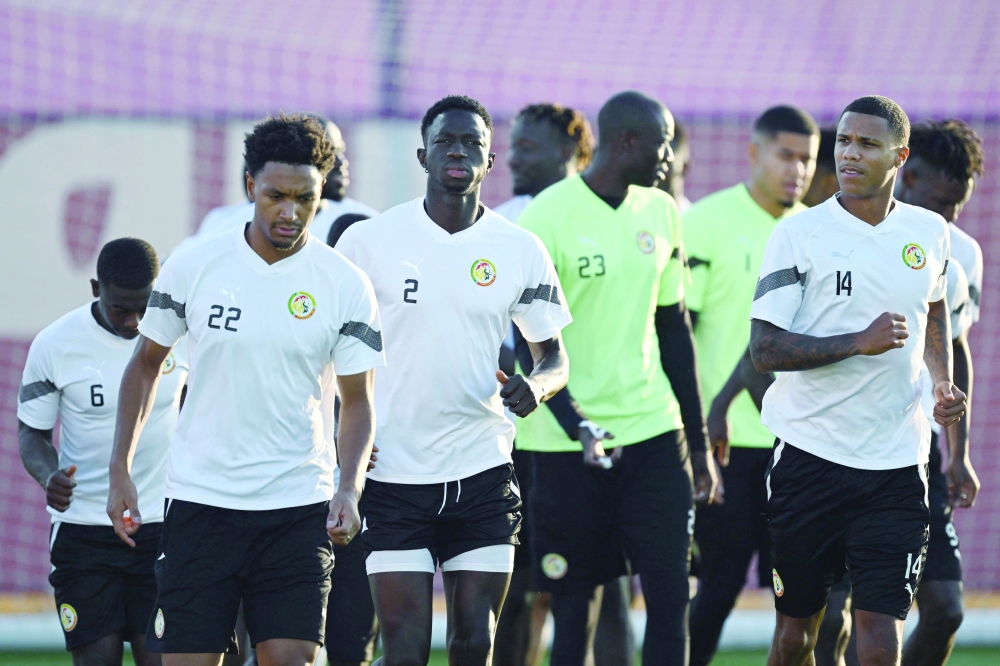Senegal's defender #22 Abdou Diallo, Senegal's defender #02 Formose Mendy and Senegal's defender #14 Ismail Jakobs attend a training session at Duhail Handball Sports Hall in Doha on November 28, 2022, on the eve of the Qatar 2022 World Cup football match between Ecuador and Senegal. (Photo by OZAN KOSE / AFP)


