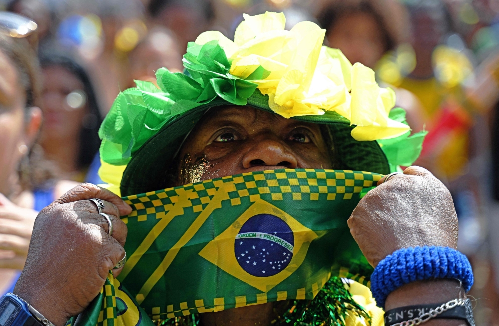A fan of Brazil reacts while watching the live broadcast of the Qatar 2022 World Cup Group G football match between Brazil and Switzerland, at the Fifa Fan Fest in Copacabana beach, Rio de Janeiro, Brazil. - AFP

