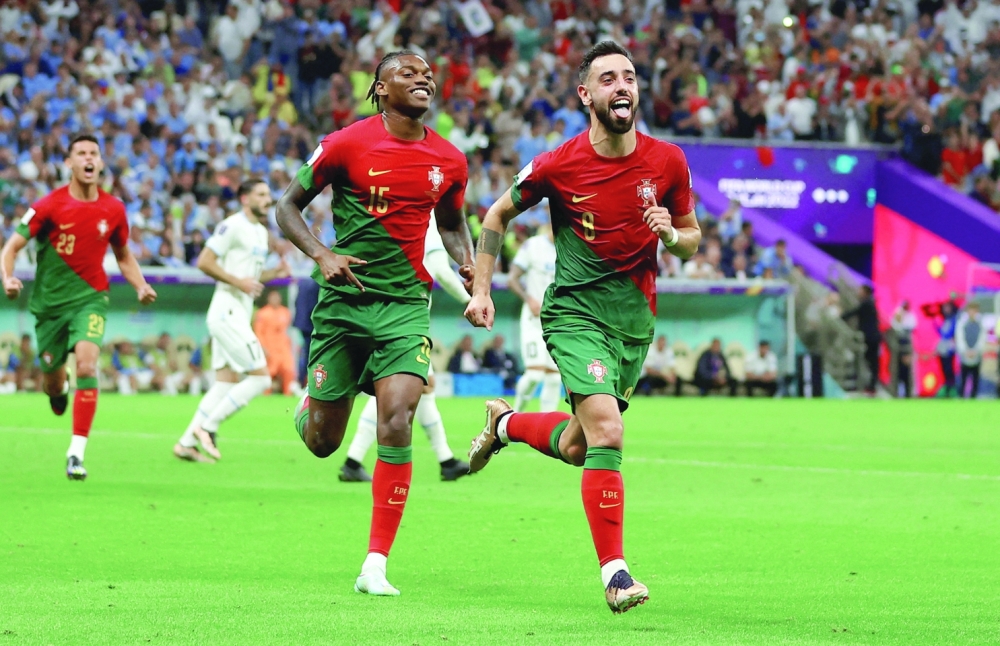 Soccer Football - FIFA World Cup Qatar 2022 - Group H - Portugal v Uruguay - Lusail Stadium, Lusail, Qatar - November 28, 2022 Portugal's Bruno Fernandes celebrates scoring their second goal with Portugal's Rafael Leao REUTERS