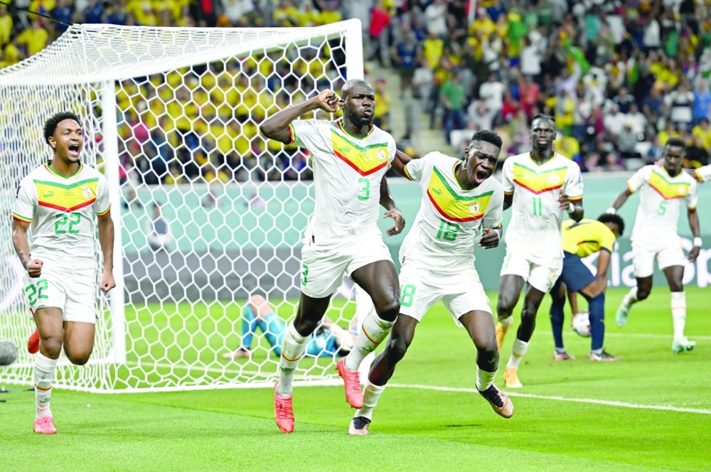 Soccer Football - FIFA World Cup Qatar 2022 - Group A - Ecuador v Senegal - Khalifa International Stadium, Doha, Qatar - November 29, 2022  Senegal's Kalidou Koulibaly celebrates scoring their second goal with teammates REUTERS/Dylan Martinez
