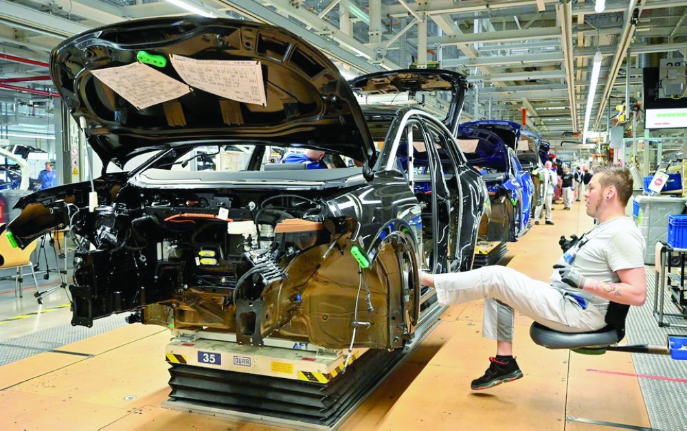 Technicians work at the production line for electric cars in Zwickau, Germany. — Reuters