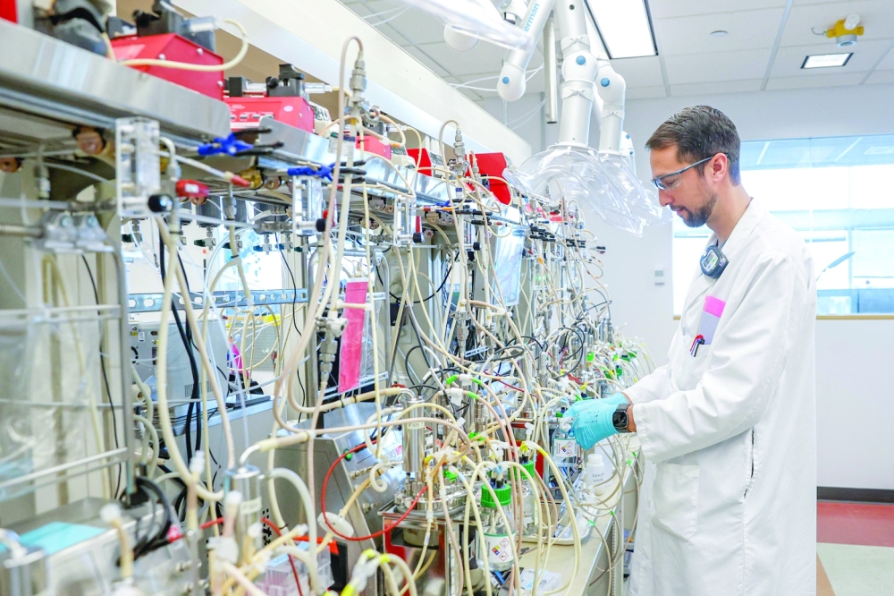 Adam Thompson, senior scientist, works at LanzaTech lab. -- AFP