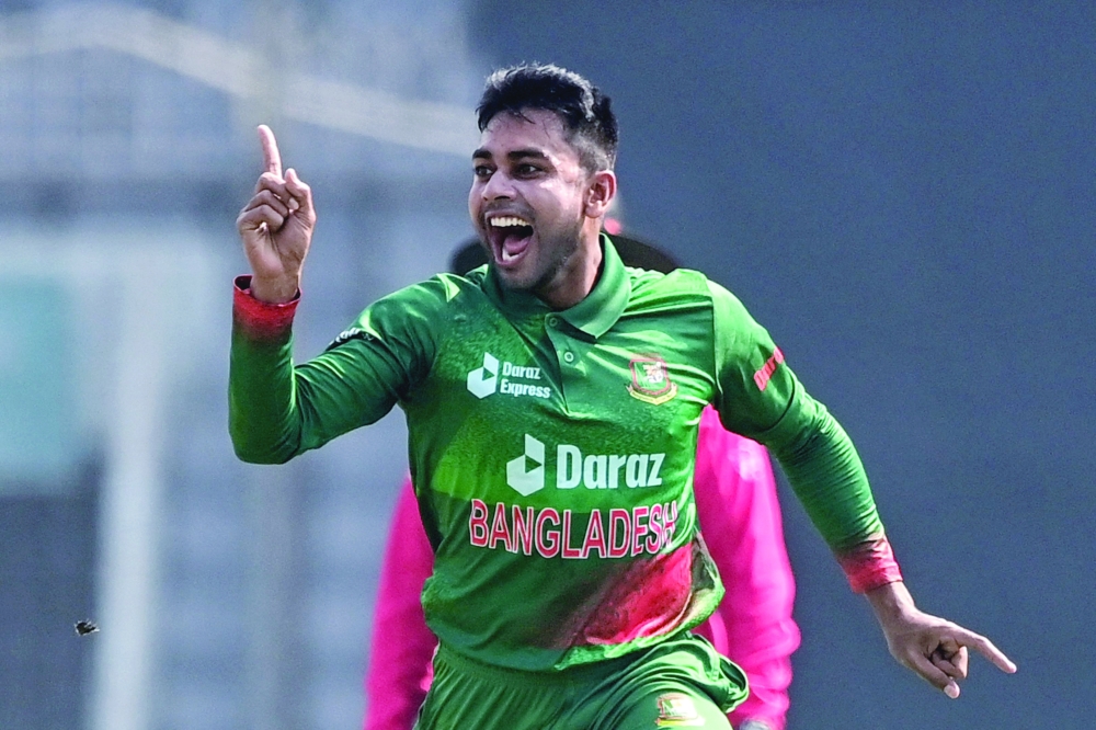 Bangladesh's Mehidy Hasan Miraz reacts after the dismissal of Indian's Shikhar Dhawan (unseen) during the first one-day international (ODI) cricket match between Bangladesh and India at the Sher-e-Bangla National Cricket Stadium in Dhaka on December 4, 2022.  (Photo by Munir uz ZAMAN / AFP)

