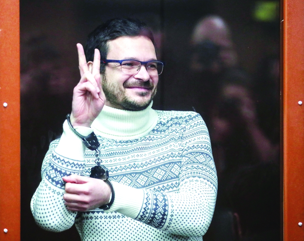 Russian opposition leader, former Moscow's municipal deputy Ilya Yashin gestures in a defendants' glass cage prior to a verdict hearing at the Meshchansky district court in Moscow on Friday. — Reuters