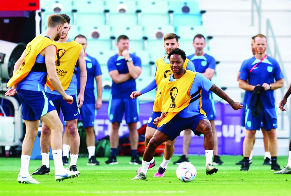 Soccer Football - FIFA World Cup Qatar 2022 - England Training - Al Wakrah SC stadium, Al Wakrah, Qatar - December 9, 2022 England's Raheem Sterling and teammates during training REUTERS/Molly Darlington

