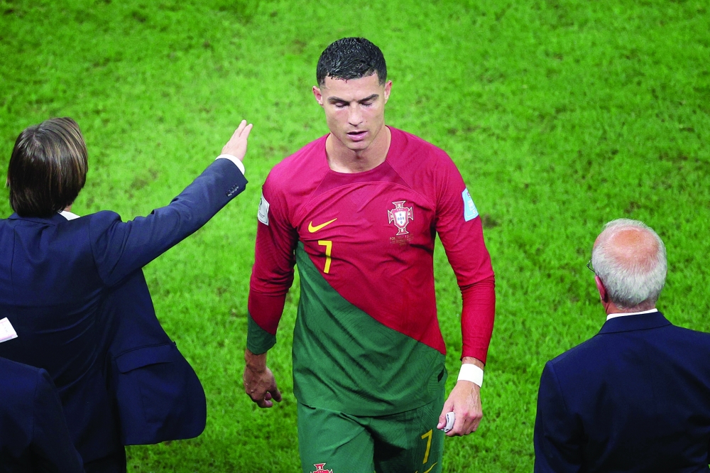 Portugal's forward #07 Cristiano Ronaldo walks off the pitch at the end of the Qatar 2022 World Cup round of 16 football match between Portugal and Switzerland at Lusail Stadium in Lusail, north of Doha on December 6, 2022. (Photo by ADRIAN DENNIS / AFP)

