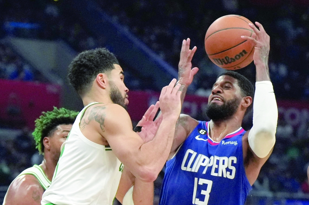 Dec 12, 2022; Los Angeles, California, USA; LA Clippers guard Paul George (13) battles for the ball with Boston Celtics forward Jayson Tatum (0) in the second half at Crypto.com Arena. The Clippers defeated the Celtics 113-93. Mandatory Credit: Kirby Lee-USA TODAY Sports
