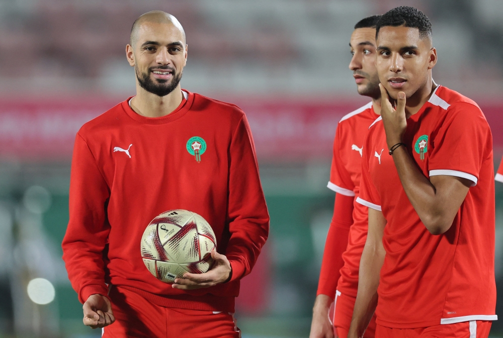 Morocco's midfielder Sofyan Amrabat (L) and midfielder Abdelhamid Sabiri take part in a training session at the Al Duhail SC Stadium in Doha on December 13 2022, on the eve of the Qatar 2022 World Cup football semi-final match between France and Morocco. (Photo by KARIM JAAFAR / AFP)

