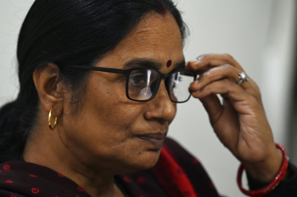In this photograph taken on November 30, 2022, Asha Devi, mother of the 2012 Delhi gang rape victim, gestures during an interview with AFP at her residence in New Delhi. Ten years ago the brutal gang rape and murder of a young woman on a Delhi bus horrified the world and shone a spotlight on high rates of sexual violence in India. But a decade after the assault many women are still scared to travel at night in India's capital, a sprawling metropolis of 20 million people. - To go with 'India-Assault' by Abhaya SRIVASTAVA
 (Photo by Money SHARMA / AFP) / To go with 'India-Assault' by Abhaya SRIVASTAVA

