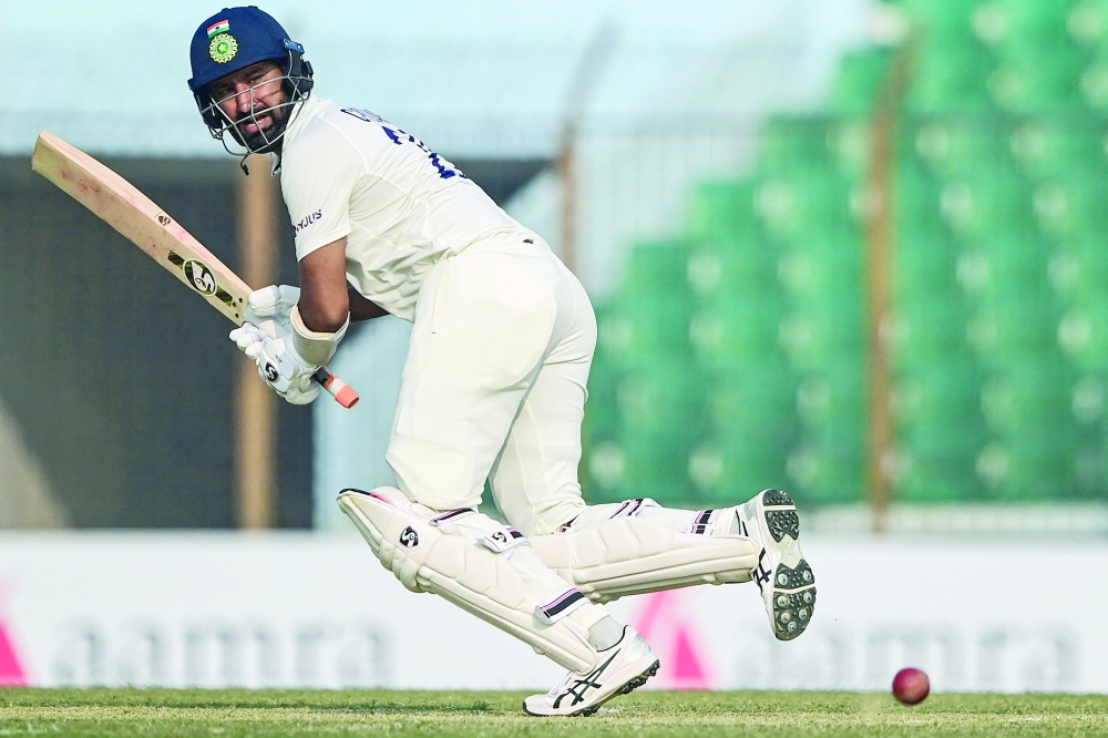 India's Cheteshwar Pujara plays a shot during the first day of the first cricket Test match between Bangladesh and India at the Zahur Ahmed Chowdhury Stadium in Chittagong on December 14, 2022.  (Photo by Munir uz ZAMAN / AFP)


