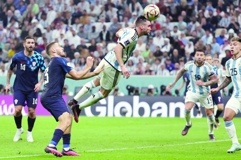 Argentina's defender #03 Nicolas Tagliafico (C) attempts to score during the Qatar 2022 World Cup football semi-final match between Argentina and Croatia at Lusail Stadium in Lusail, north of Doha on December 13, 2022.  (Photo by JACK GUEZ / AFP)

