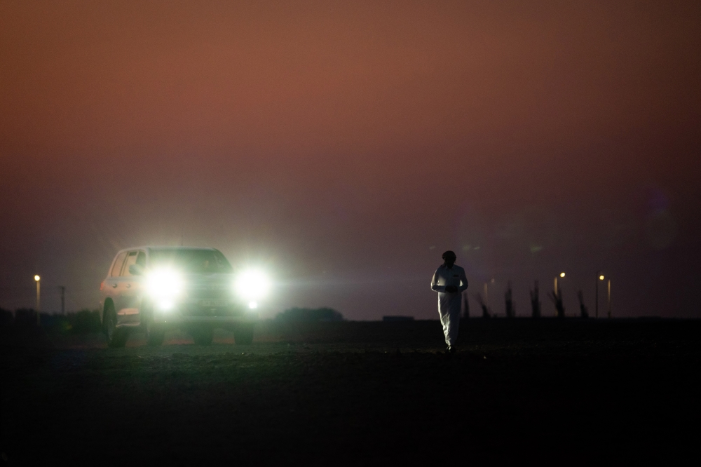 Falconers prepare to drive home after sunset after training their birds outside of Al Khor, Qatar on December 3, 2022.  (Erin Schaff/The New York Times)