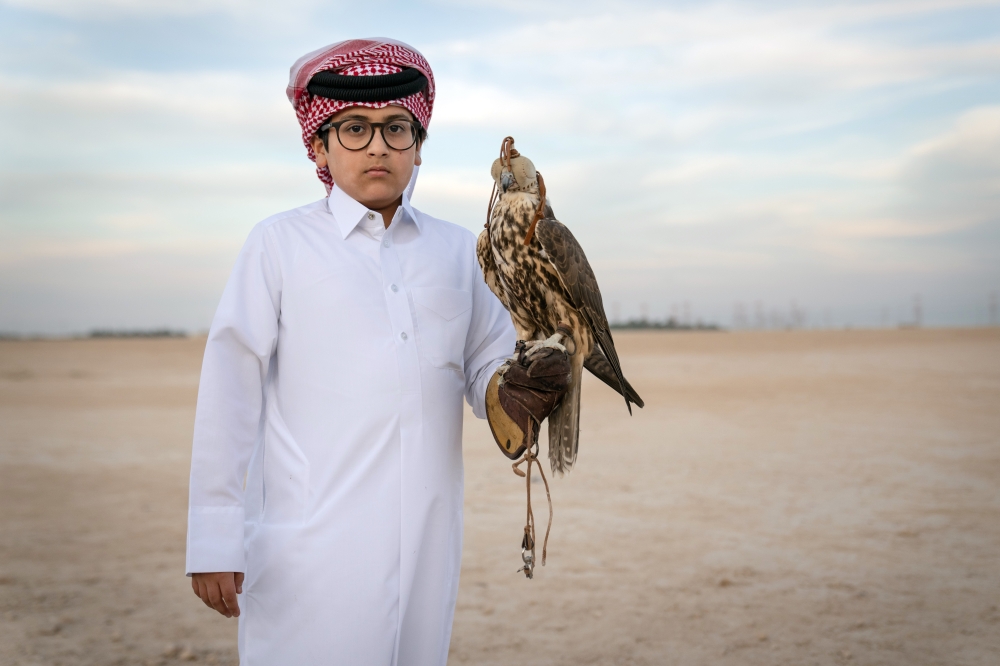 Talal al-Humaidi, 13, took an interest in falconry a few years ago  to the delight of his father, who immediately bought him a falcon of his own.  (Erin Schaff/The New York Times)