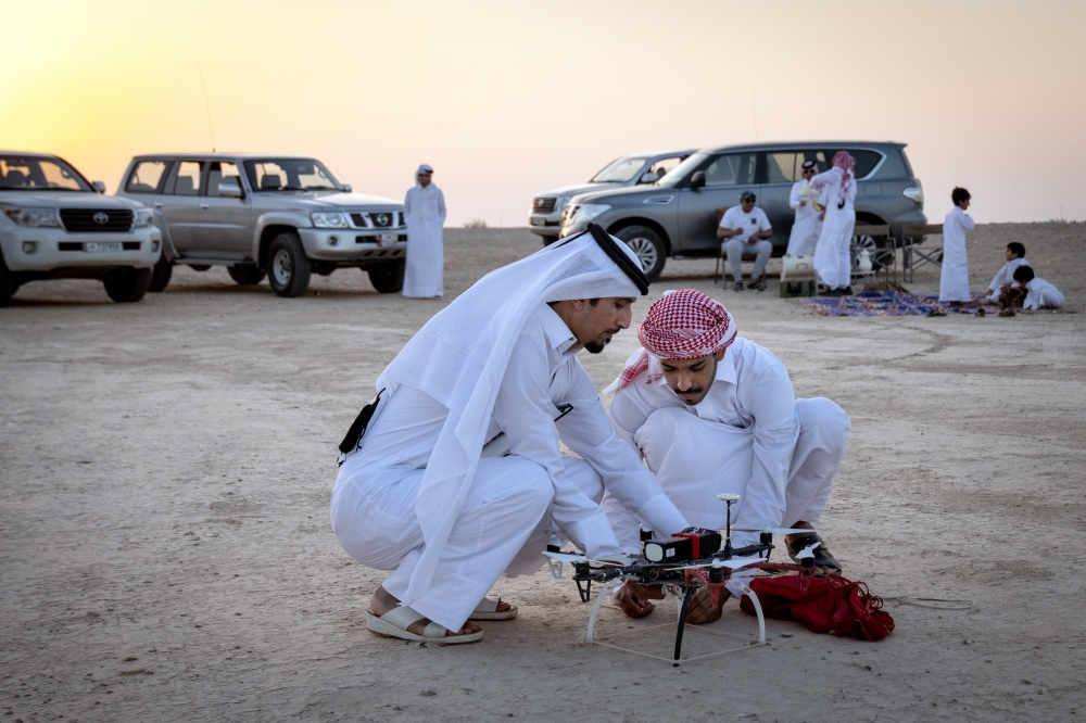 Falconers prepare to launch a drone during a training session for their falcons outside of Al Khor, Qatar, on Dec. 3, 2022. (Erin Schaff/The New York Times)