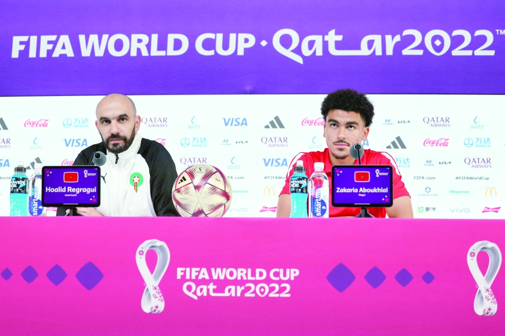 Morocco's coach Walid Regragui (L) and Morocco's forward Zakaria Aboukhlal give a press conference at the Qatar National Convention Center (QNCC) in Doha on December 16, 2022, on the eve of the Qatar 2022 World Cup third place football match between Croatia and Morocco.  (Photo by KARIM JAAFAR / AFP)