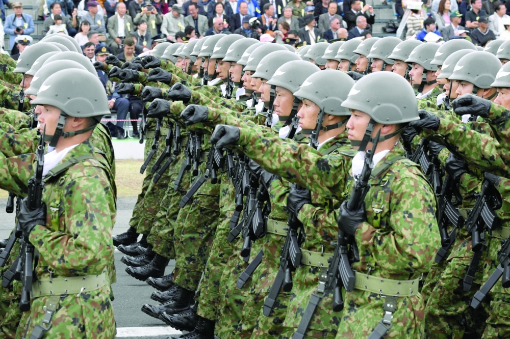 Soldiers from the Japan Ground Self-Defence Force taking part in a military review at the Ground Self-Defence Force's Asaka training ground in Saitama prefecture. - AFP File