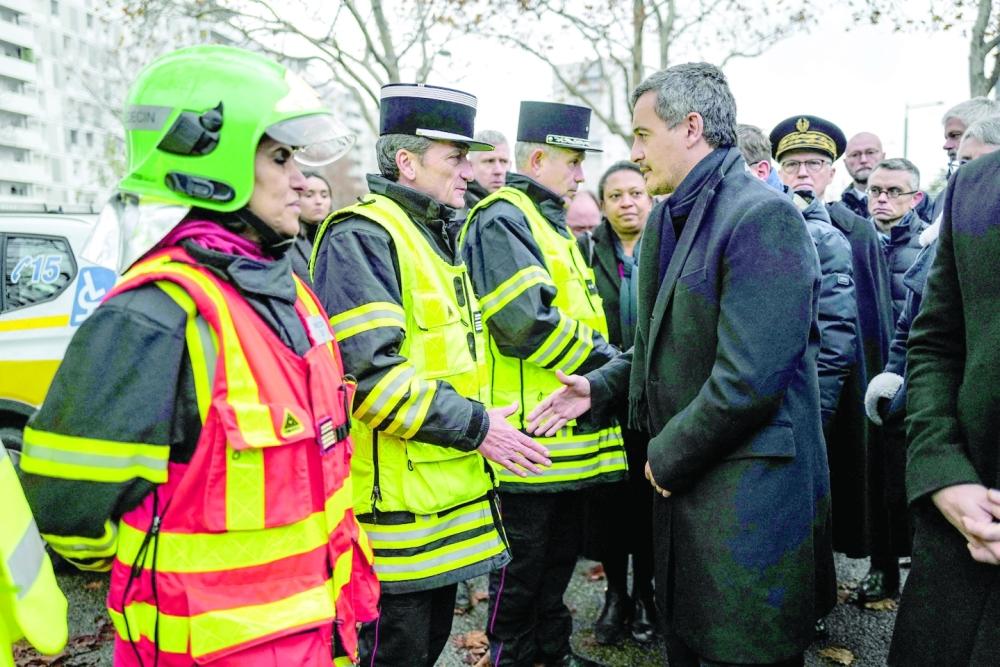 French Interior Minister Gerald Darmanin (R) meets rescue units members in the Mas-Du-Taureau neighbourhood of Vaulx-en-Velin, in the northern outskirts of Lyon. - AFP