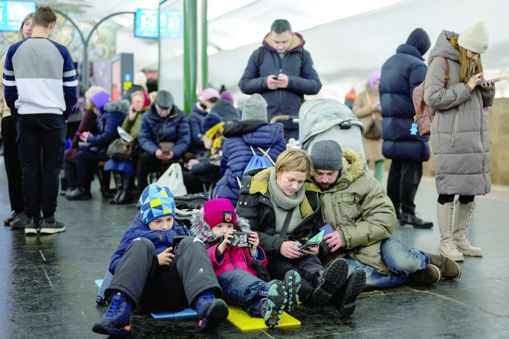 People shelter inside a metro station during massive Russian missile attacks in Kyiv. - Reuters
