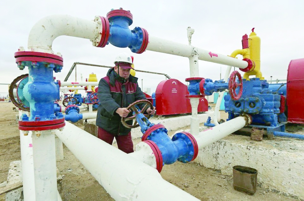 A worker checks the pressure of pumps at an oil-pumping station in the Uzen oil and gas field in the Mangistau Region of Kazakhstan.  — Reuters
