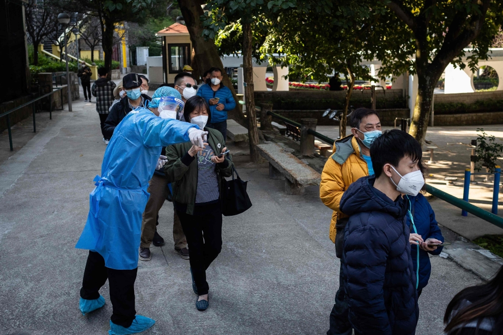 People queue for a Covid-19 test at a facility in Macau on December 21, 2022.