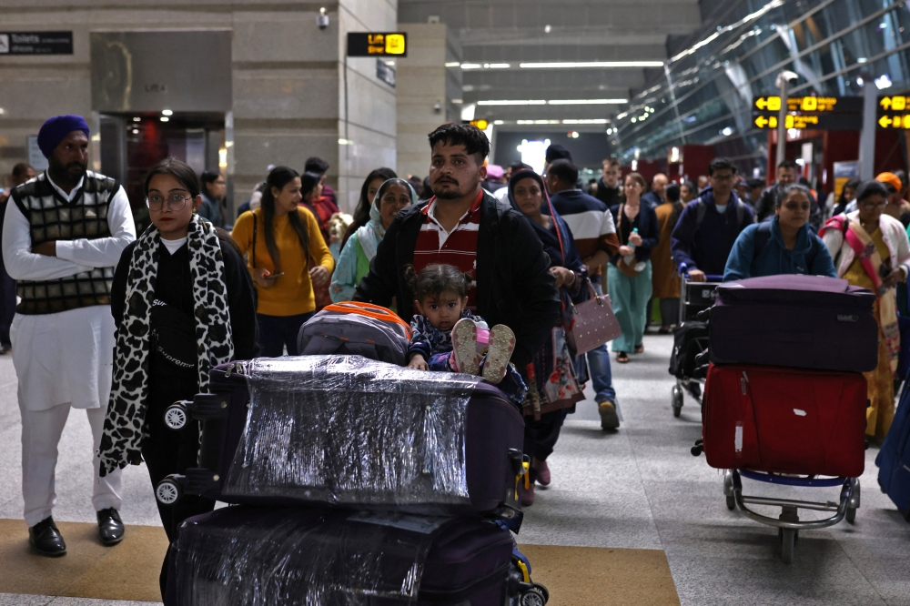 Travellers at the departure area of Indira Gandhi International Airport in New Delhi. — Reuters