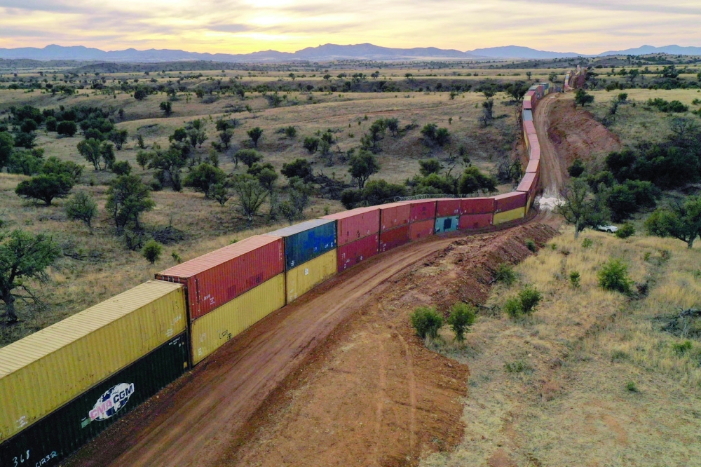 From the air, the makeshift wall of shipping containers along the US-Mexico border in Arizona resembles an enormous stationary freight train. -- AFP