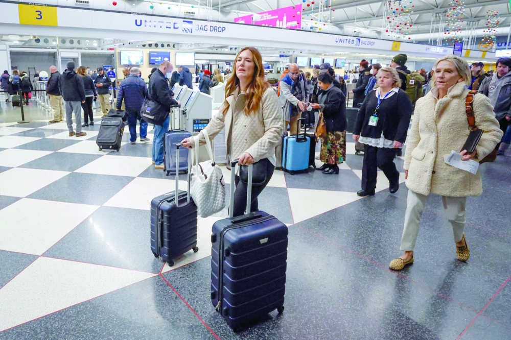 Travelers arrive for their flights at O'Hare International Airport in Chicago.  -- AFP