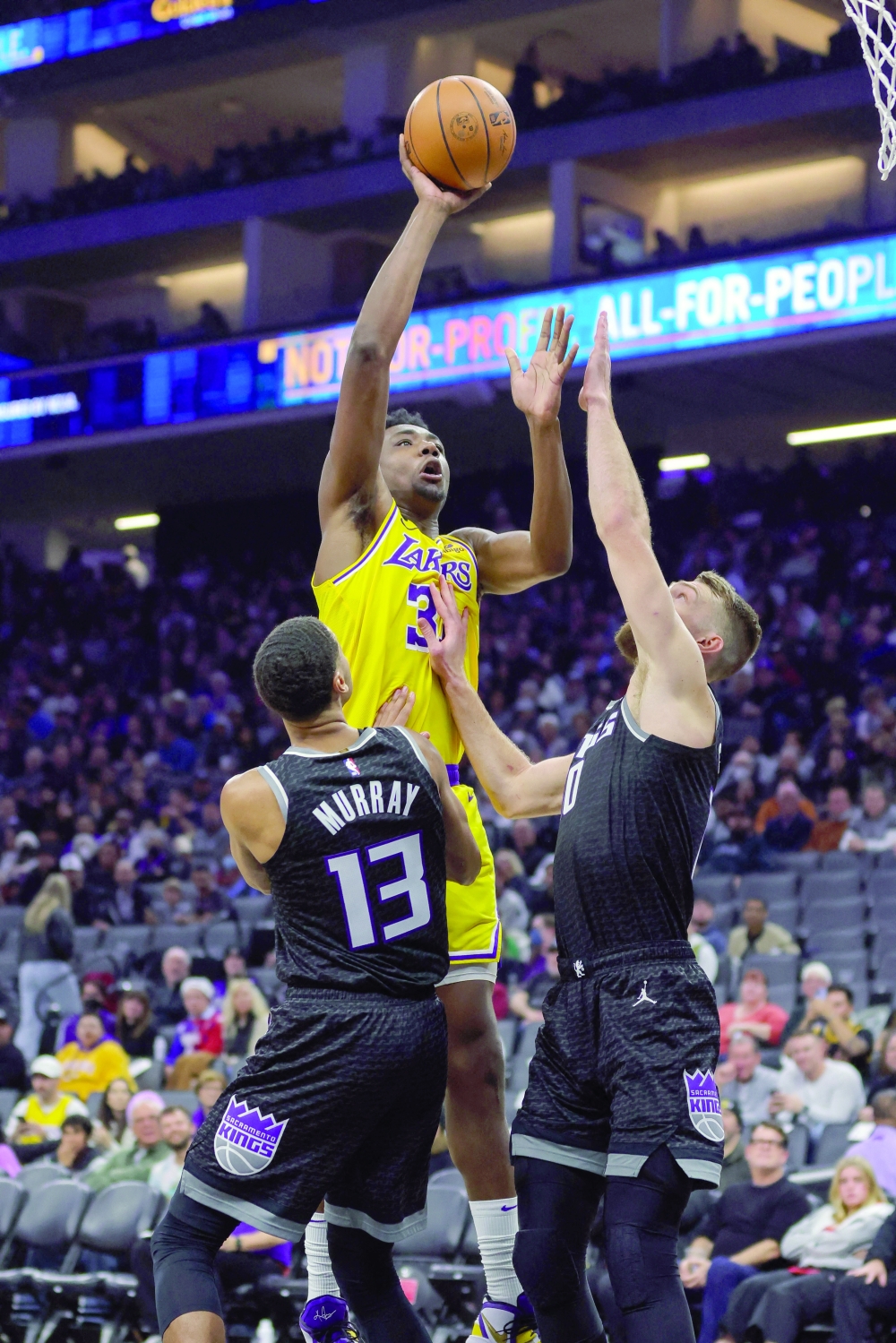 Dec 21, 2022; Sacramento, California, USA; Los Angeles Lakers center Thomas Bryant (31) shoots over Sacramento Kings forward Domantas Sabonis (10) during the third quarter at Golden 1 Center. Mandatory Credit: Sergio Estrada-USA TODAY Sports
