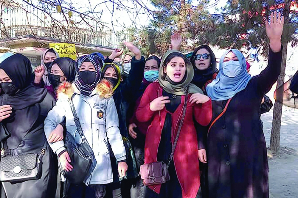 Women protest in Kabul on Thursday against the ban on university education. -- AFP