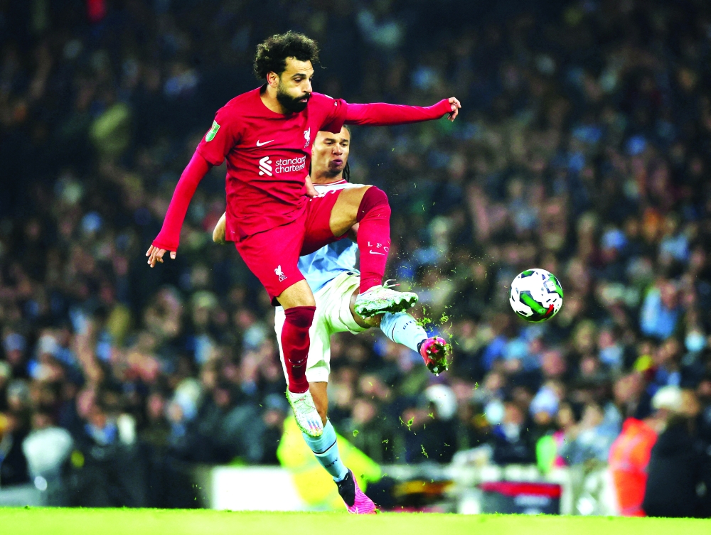 Soccer Football - Carabao Cup - Round of 16 - Manchester City v Liverpool - Etihad Stadium, Manchester, Britain - December 22, 2022 Liverpool's Mohamed Salah in action with Manchester City's Nathan Ake REUTERS