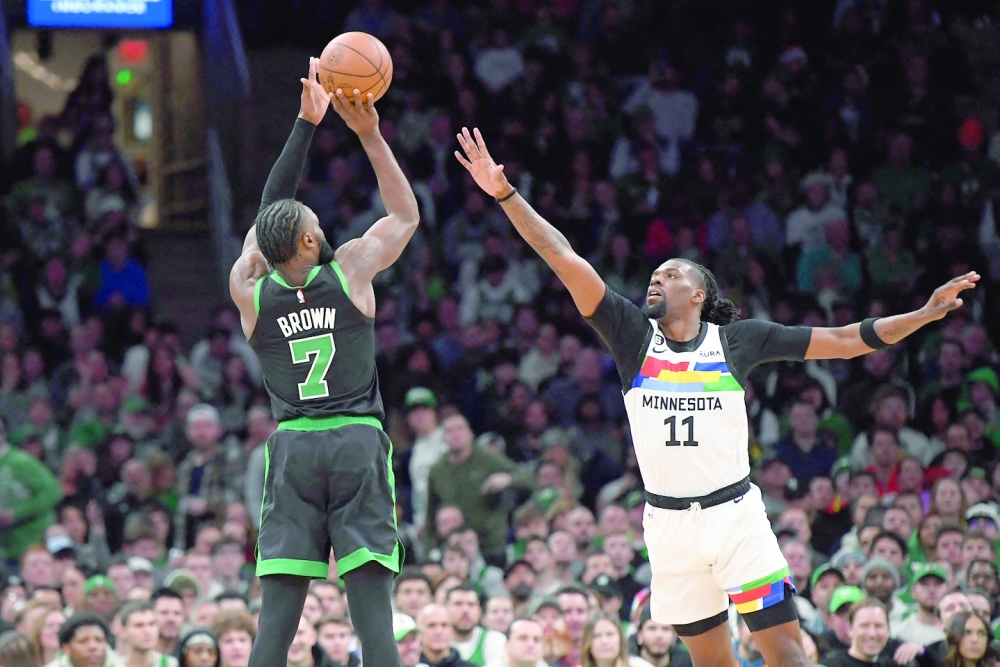 Dec 23, 2022; Boston, Massachusetts, USA;  Boston Celtics guard Jaylen Brown (7) shoots the ball over Minnesota Timberwolves center Naz Reid (11) during the second half at TD Garden. Mandatory Credit: Bob DeChiara-USA TODAY Sports
