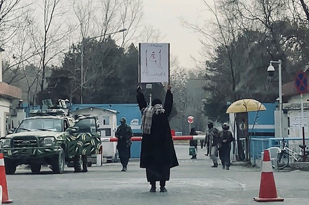 This picture taken on December 25, 2022 shows student Marwa protesting alone against the ban on women's higher education, outside the Kabul University