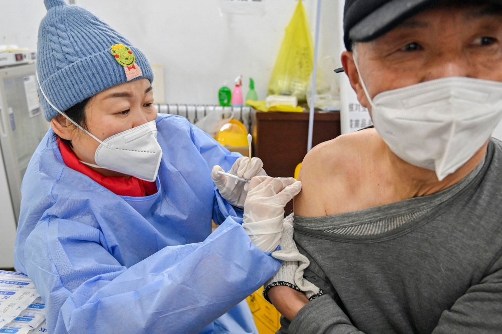 A man receives a Covid-19 coronavirus vaccine in Qingzhou, in China's eastern Shandong province on December 29, 2022. 