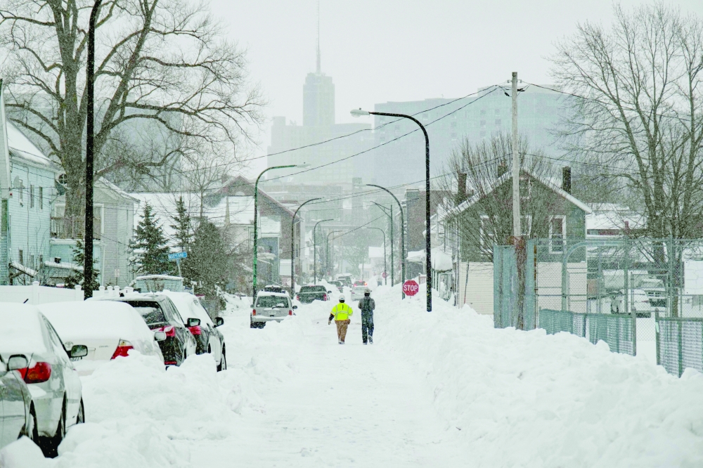 National Grid workers respond to a downed utility pole in Buffalo, New York. -- AFP
