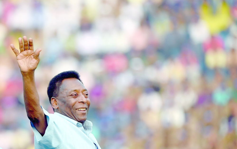 (FILES) In this file photo taken on October 16, 2015 Former Brazilian footballer Pele greets the crowd before the start of the Under-17 boys final match of the Subroto Cup in New Delhi. Brazilian football icon Pele, widely regarded as the greatest player of all time and a three-time World Cup winner who masterminded the 'beautiful game', died on December 29, 2022 at the age of 82, after battling kidney problems and colon cancer.  (Photo by Money SHARMA / AFP)

