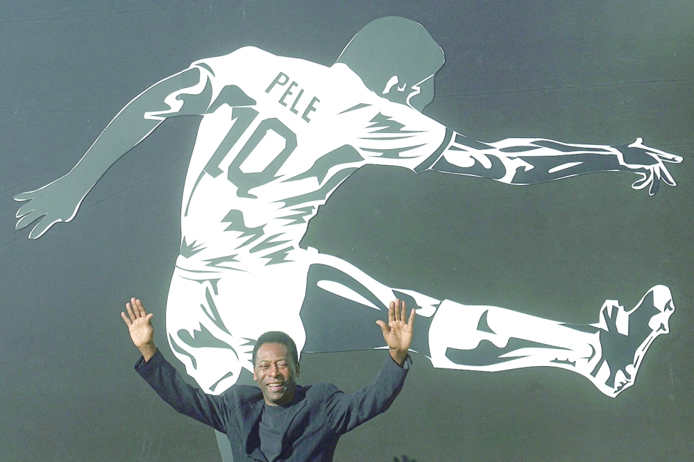 (FILES) In this file photo taken on June 25, 2008 Brazilian soccer legend Edson Arantes do Nacimento, known as Pele, raises his arms during the opening ceremony of the "Marks of the King" exhibition in Brasilia. Brazilian football icon Pele, widely regarded as the greatest player of all time and a three-time World Cup winner who masterminded the 'beautiful game', died on December 29, 2022 at the age of 82, after battling kidney problems and colon cancer.  (Photo by JOEDSON ALVES / AFP)

