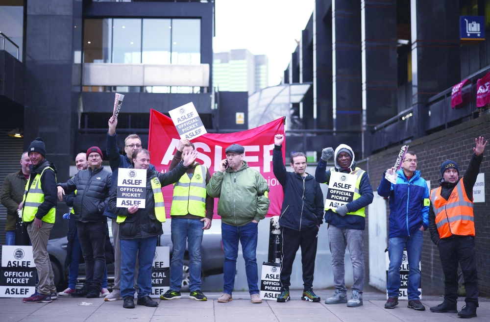 Striking rail workers picket outside Euston station in London on Thursday. -- Reuters