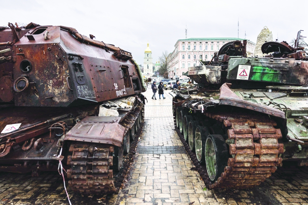 Pedestrians look at the destroyed Russian military vehicles at an open air exhibition of destroyed Russian equipment in Kyiv on Thursday. -- AFP
