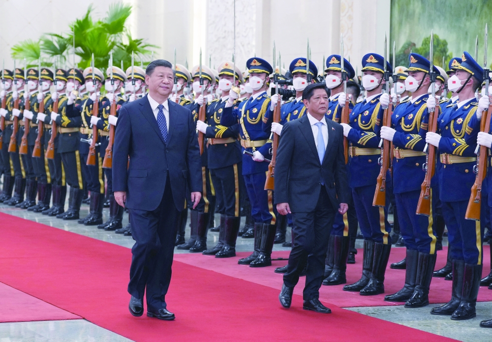 Chinese President Xi Jinping and Philippine President Ferdinand Marcos Jr review the honour guard during a welcome ceremony at the Great Hall of the People in Beijing. -- Reuters