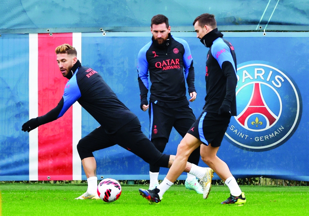 Soccer Football - Coupe de France - Paris St Germain Training - Ooredoo Training Centre, Saint-Germain-en-Laye, France - January 5, 2023 Paris St Germain's Lionel Messi with Sergio Ramos and Fabian Ruiz during training REUTERS/Gonzalo Fuentes
